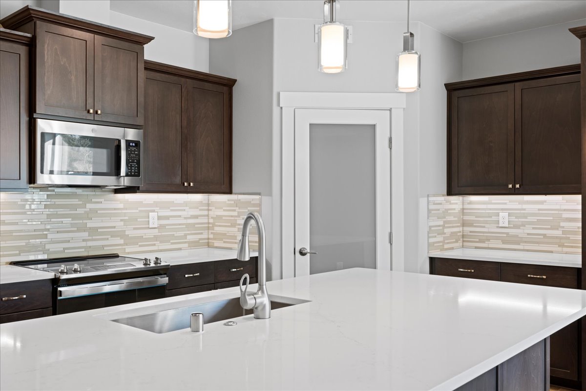 image of kitchen area with dark brown cabinets